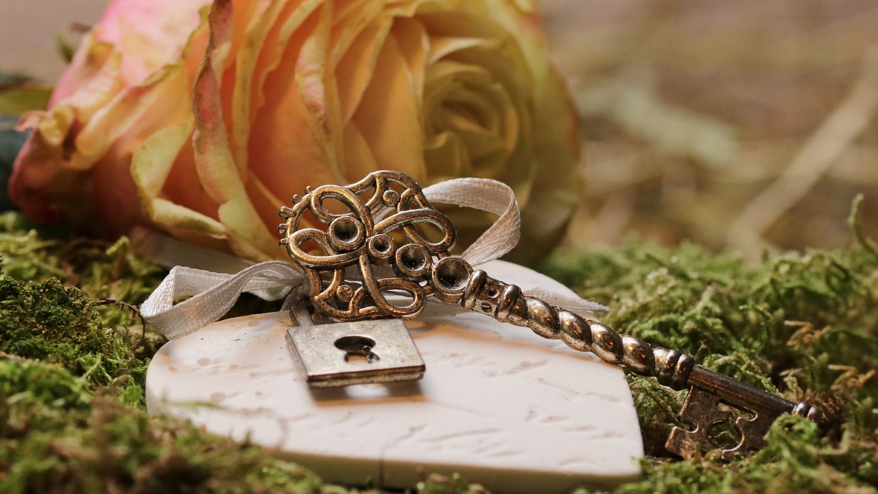 A Rose flower with a Key next to it
