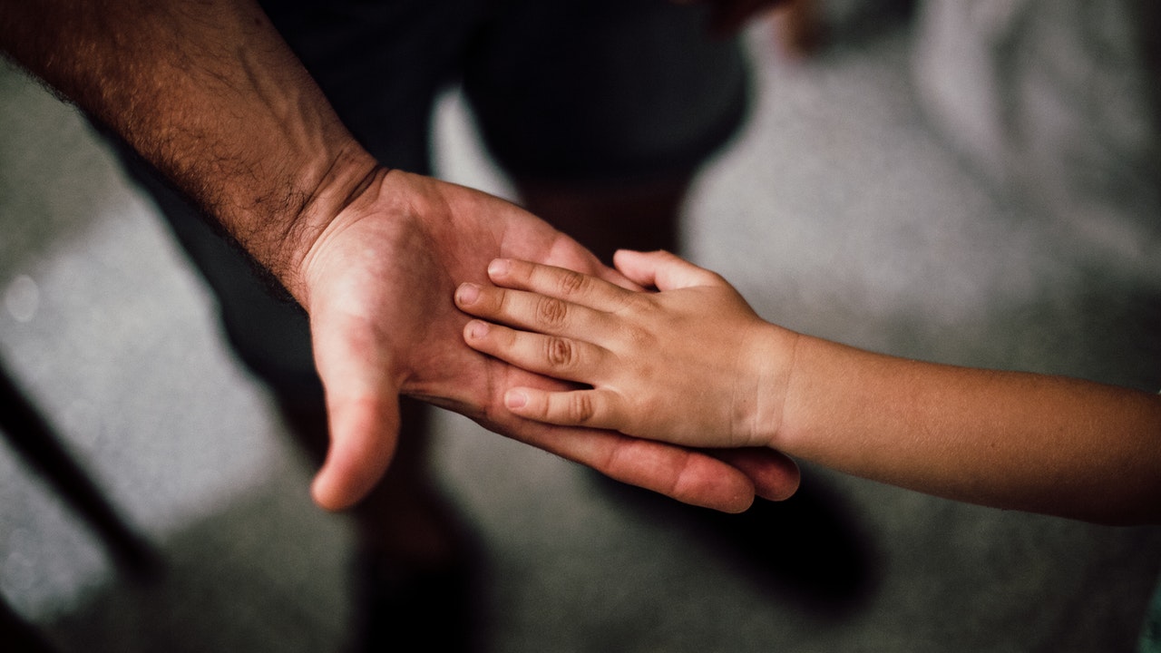 Selective focused photography of child's hand in an adults hand