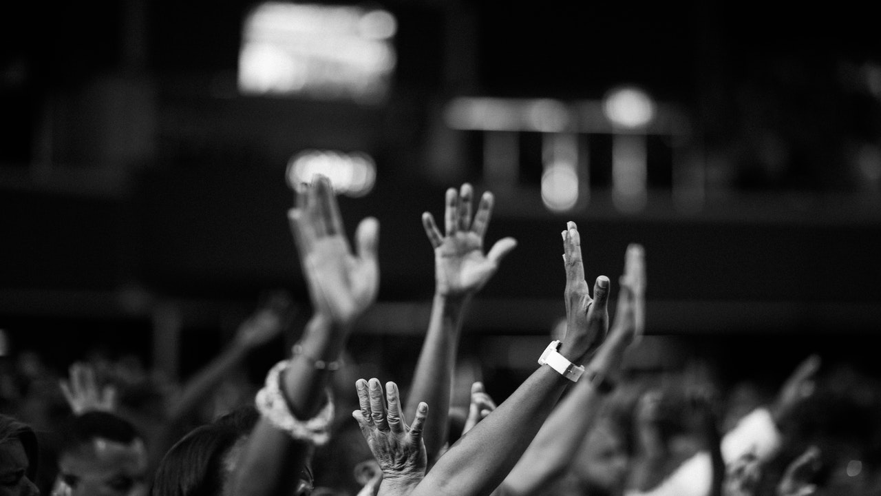 People raising hands in surrender to God.