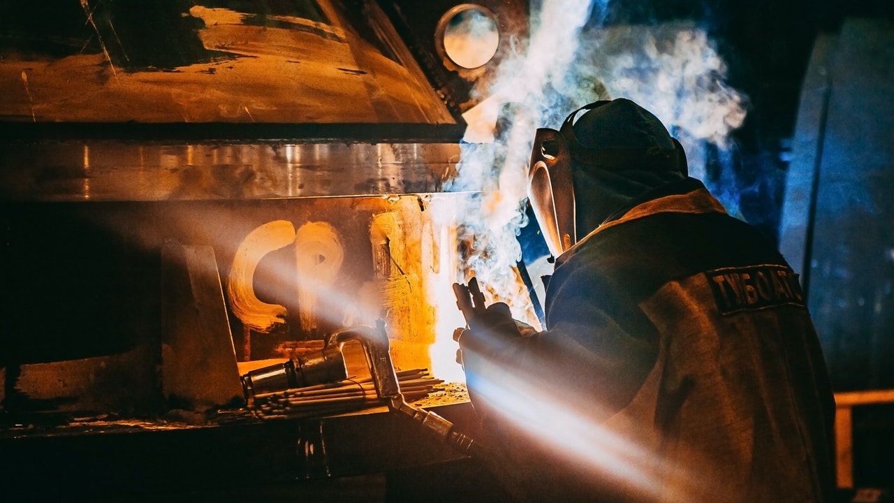 A man with welding gears, working in extreme situations.